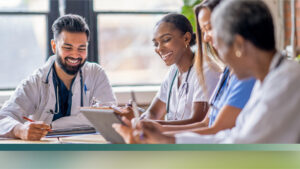 A decorative image of three healthcare workers collaborating